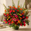 Large mixed bouquet of roses and daisies in a green vase