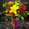 Bright mixed bouquet with yellow lilies, red roses, and a magenta vase