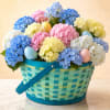 Basket of pastel hydrangeas with decorated eggs