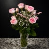 Pale pink roses with fuller blush centers create an immediate soft-focus impression-perfect