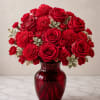 A lush cluster of red roses and carnations makes a bold romantic