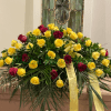 The spray is densely layered across the top of the casket, with