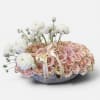 Blush and white rose arrangement in a low round container