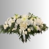 White floral casket spray with a cream ribbon bow
