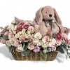 Basket of pastel flowers with a plush bunny