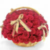 Basket of red roses with gold ribbons