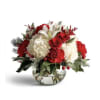 Red and white floral arrangement in a clear glass bowl vase