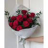 Bouquet of red roses wrapped in white paper