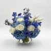 A cool, rounded cluster of blue hydrangeas and creamy white roses makes