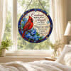 Round stained-glass panel with a red cardinal and blue flowers