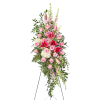 Tall standing floral spray with pink roses and lilies on an easel