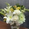 A graceful arrangement blending soft blue hydrangeas, elegant white lilies, creamy white