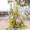 Extravagant arrangement filled with variety of wildflowers. 
