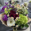 Mixed bouquet with white gerbera, purple blooms, and green hydrangea