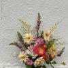 A unique arrangement in black vase, with dahlias, orchids, snap dragons and