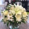 This serene arrangement cheers the heart. Is creamy roses and snowy lilies