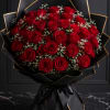 Bouquet of red roses wrapped in black paper with gold trim