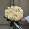 Bouquet of cream roses tied with a white ribbon