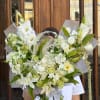 Large white bouquet with lilies, roses, and mixed blooms