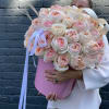 Large bouquet of blush and cream roses in a pink hat box