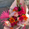 Bouquet of pink and orange roses with tulips and pink palm fronds