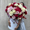 Large bouquet of red, white, and pale pink roses in a white hat box