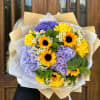Bouquet of yellow sunflowers, purple hydrangeas, and small white daisies