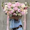 Large basket of pink and white flowers with ribbon streamers