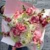 Bouquet of pink and white flowers wrapped in pink paper