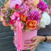 Pink and orange mixed bouquet in a pink box with ribbon