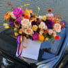 Mixed bouquet in a white gift box with purple and orange ribbons