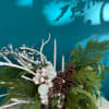 Winter centerpiece with pinecones, white accents, and silver candles