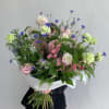 Large bouquet of pink and white flowers with blue accents