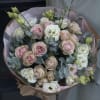 Bouquet of blush and white roses with eucalyptus in pink wrap