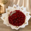 Bouquet of red roses with a jeweled crown and white wrap