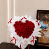 Heart-shaped bouquet of red roses with white wrapping and red ribbons