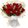 Bouquet of red roses wrapped in white paper with gold trim