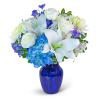 White lilies, roses, hydrangea, and purple flowers in a blue vase