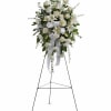 White floral standing spray on an easel with ribbon