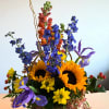 Basket arrangement with sunflowers, blue flowers, and purple irises