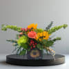 The charm of a golden sunrise. Cheerful mix of fresh blooms 