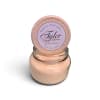 Peach scented candle in a glass jar with a round lid