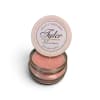 Pink scented candle in a glass jar with a round lid