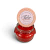Red scented candle in a glass jar with a printed lid