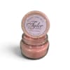 Pink scented candle in a glass jar with a patterned lid