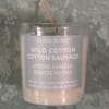 Glass votive candle labeled Wild Cotton Cotton Sauvage