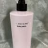 Pink body lotion bottle with a black pump dispenser