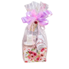 Gift basket wrapped in clear plastic with a lavender bow and floral box