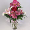 Pink and white mixed bouquet in a glass vase with a ribbon