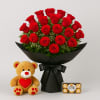 Bouquet of red roses with a teddy bear and a box of chocolates